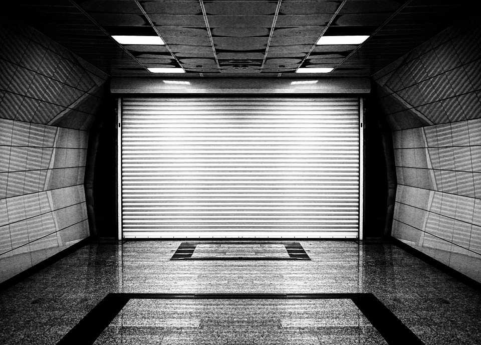 A garage with a white roller shutters